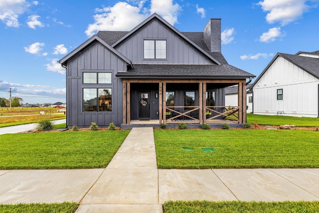 modern farmhouse featuring a front yard and covered porch