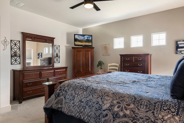 bedroom featuring vaulted ceiling, light colored carpet, and ceiling fan