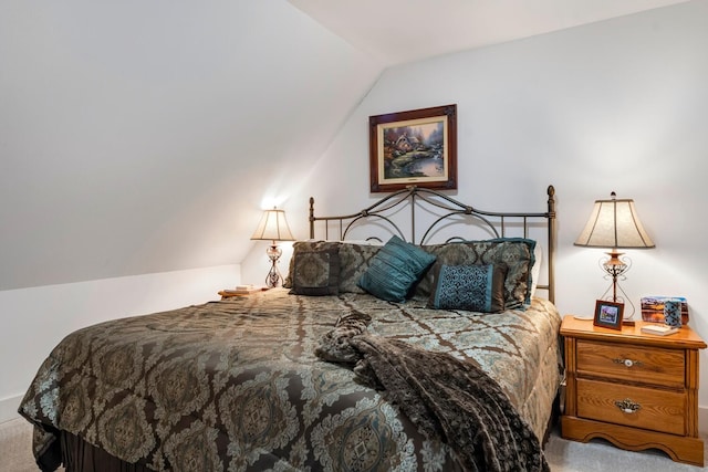 carpeted bedroom with lofted ceiling