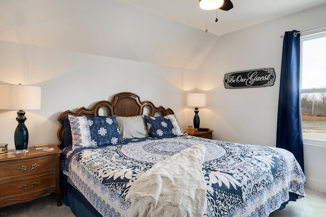 bedroom featuring carpet floors, vaulted ceiling, and ceiling fan