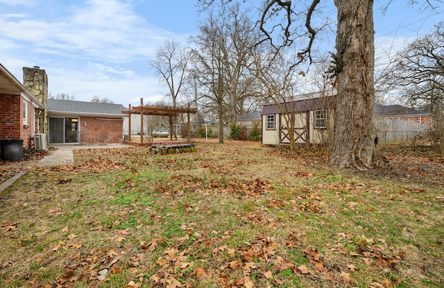 view of yard with a patio, a shed, and a pergola