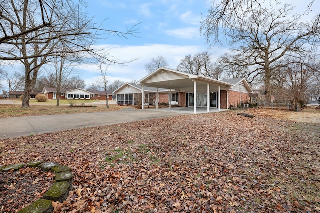 back of house featuring a carport