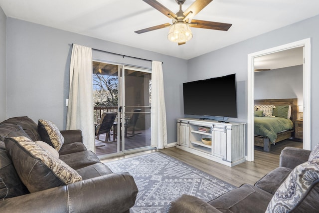 living room featuring ceiling fan and light wood-type flooring