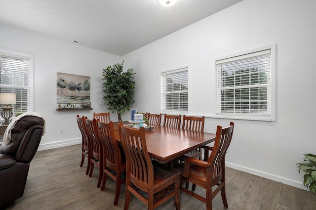 dining space with dark wood-type flooring