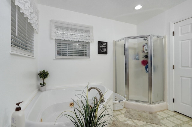 bathroom featuring shower with separate bathtub