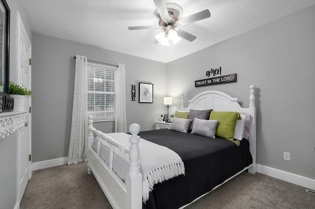 carpeted bedroom with a textured ceiling and ceiling fan