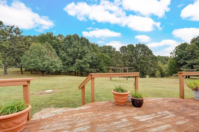 wooden deck featuring a yard