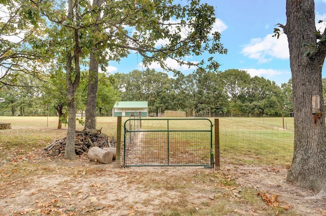 view of gate featuring a yard