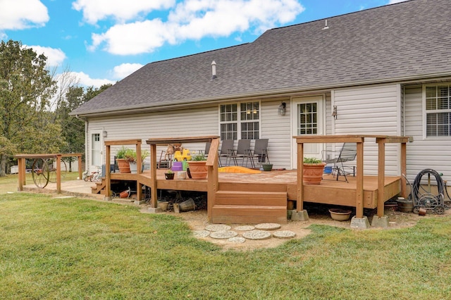 rear view of property featuring a yard and a deck