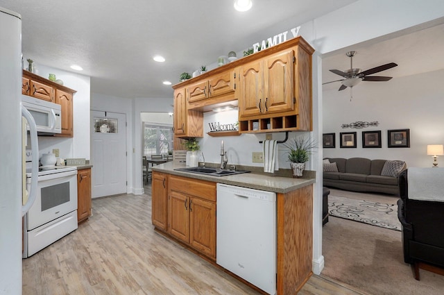 kitchen with ceiling fan, white appliances, sink, and light wood-type flooring