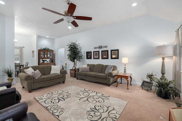 carpeted living room with lofted ceiling and ceiling fan