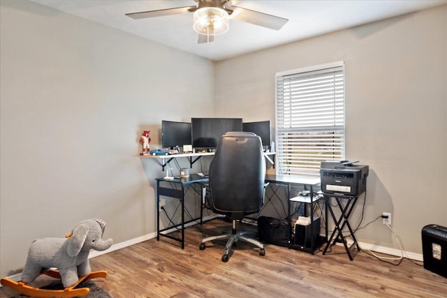 office area featuring a ceiling fan, wood finished floors, and baseboards
