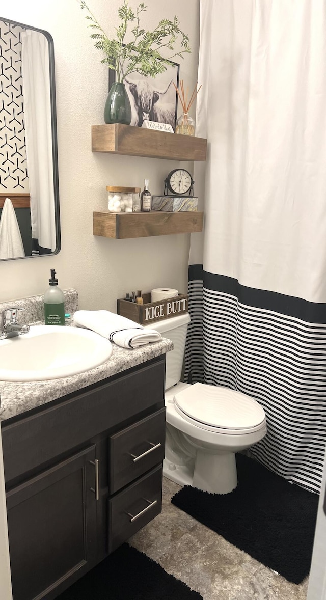 bathroom featuring toilet and vanity