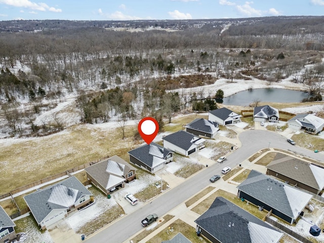 snowy aerial view with a water view