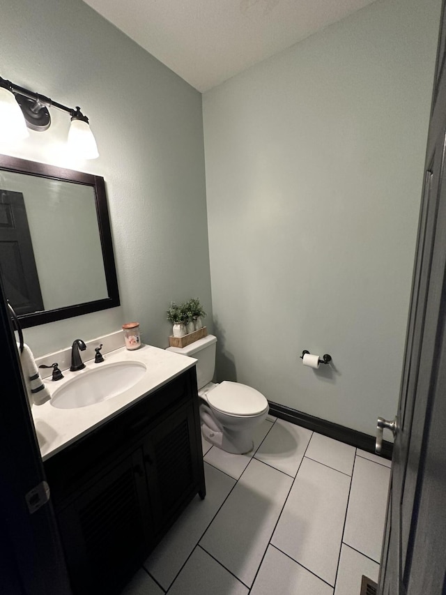 bathroom featuring tile patterned floors, vanity, and toilet