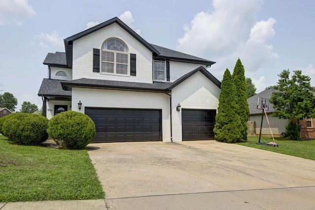 view of front property with a garage and a front lawn