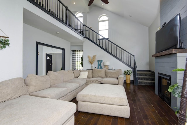 living room featuring a high ceiling, dark hardwood / wood-style floors, and ceiling fan