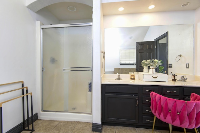 bathroom featuring vanity, an enclosed shower, and tile patterned floors