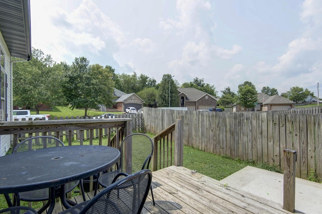 wooden terrace featuring a yard