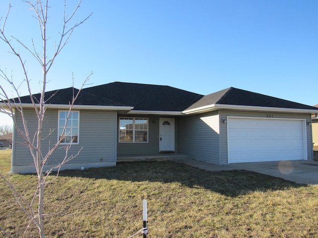 ranch-style home featuring an attached garage, driveway, and a front lawn