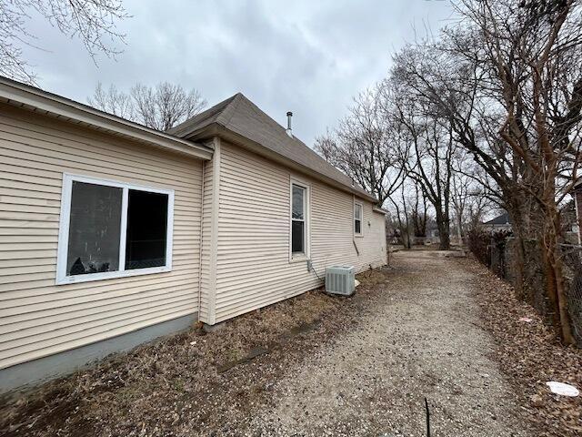 view of side of home with central AC