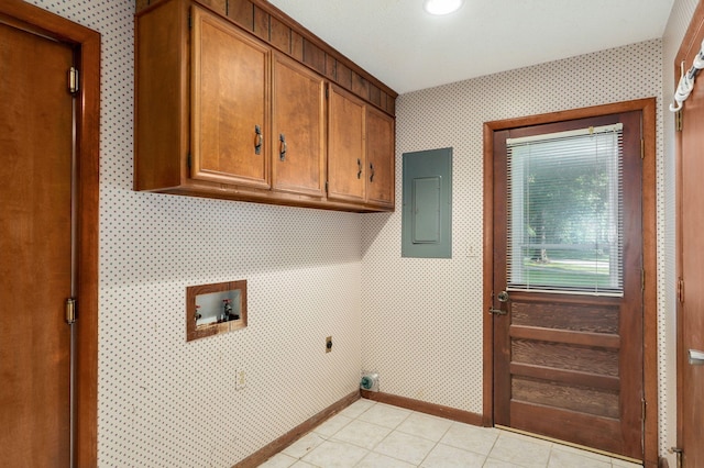 washroom featuring light tile patterned flooring, cabinets, washer hookup, and electric panel