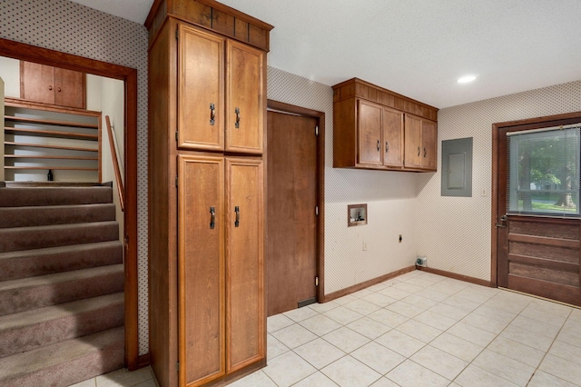 clothes washing area with gas dryer hookup, cabinets, electric panel, hookup for a washing machine, and electric dryer hookup