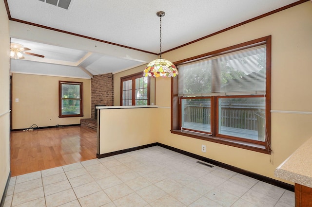 unfurnished room with a fireplace, vaulted ceiling, ornamental molding, and a textured ceiling