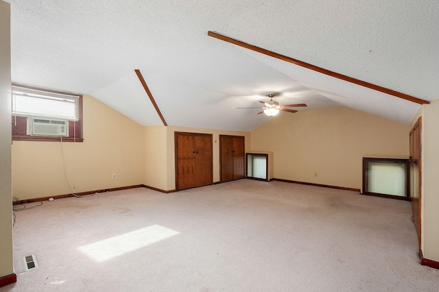 additional living space with lofted ceiling, light colored carpet, a textured ceiling, and cooling unit