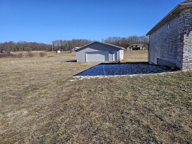 view of yard with a garage and an outdoor structure