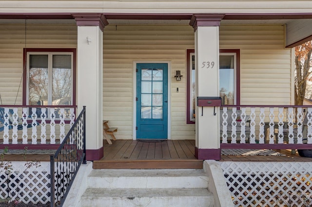 doorway to property featuring covered porch