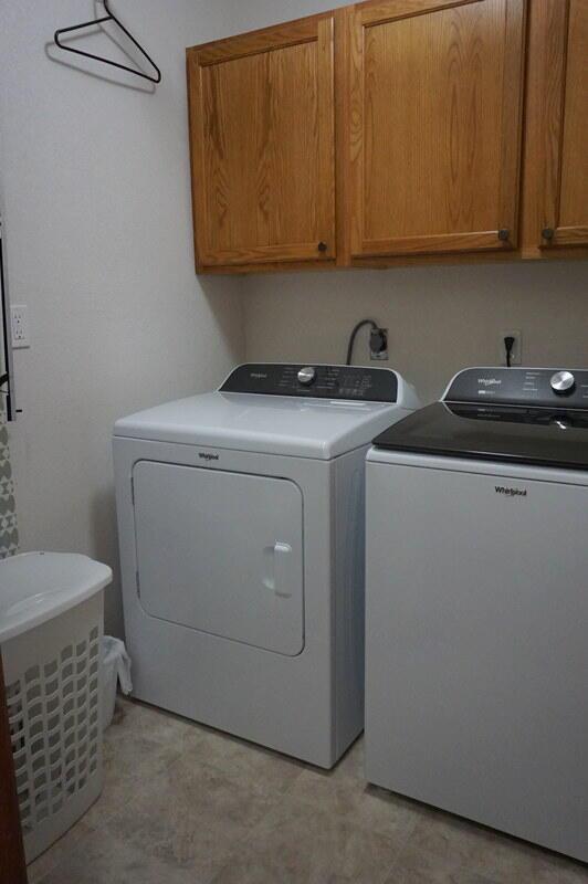 laundry room with cabinets and washer and dryer