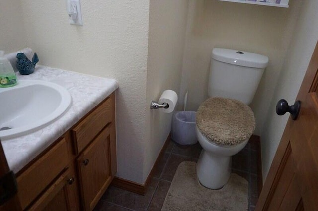 bathroom with vanity, toilet, and tile patterned flooring