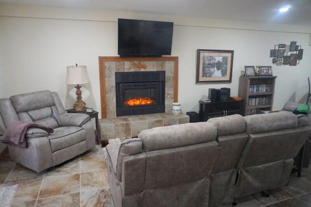 living room with a tile fireplace