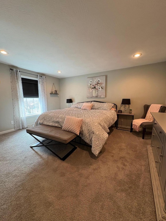 bedroom with carpet floors and a textured ceiling