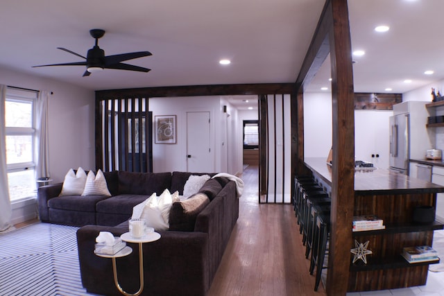 living room with ceiling fan and hardwood / wood-style floors