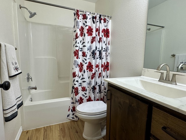 full bathroom with toilet, vanity, shower / bathtub combination with curtain, and hardwood / wood-style floors