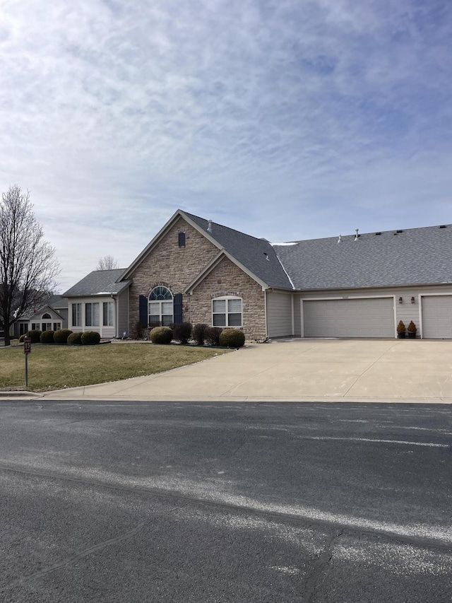 ranch-style house with a garage and a front yard