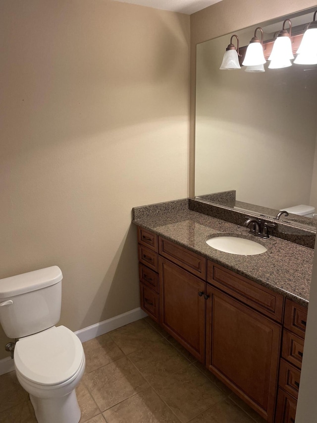 bathroom with tile patterned floors, vanity, and toilet