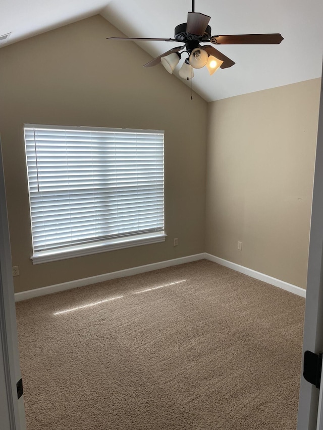 carpeted empty room featuring ceiling fan and vaulted ceiling