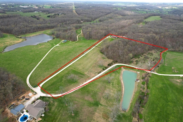 bird's eye view with a water view and a forest view
