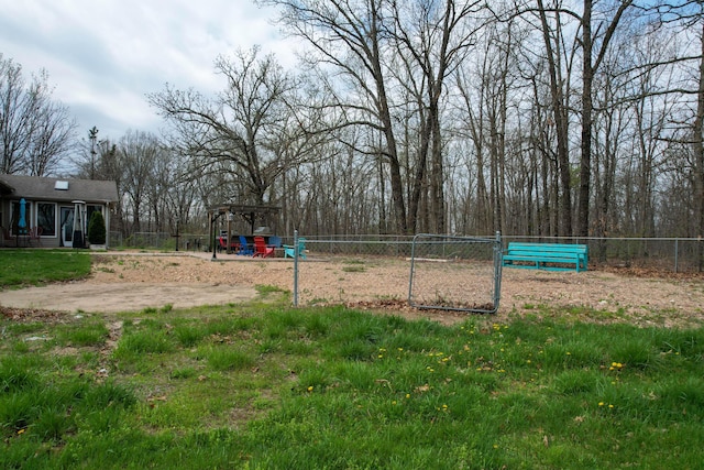 view of property's community featuring fence and playground community