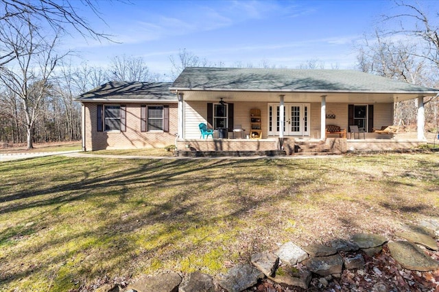 ranch-style house with a front lawn, french doors, and covered porch