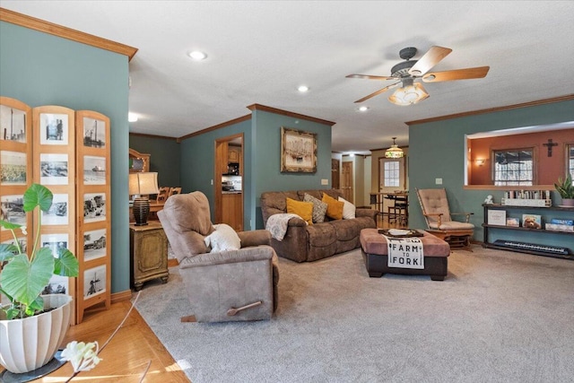 carpeted living room featuring crown molding and ceiling fan