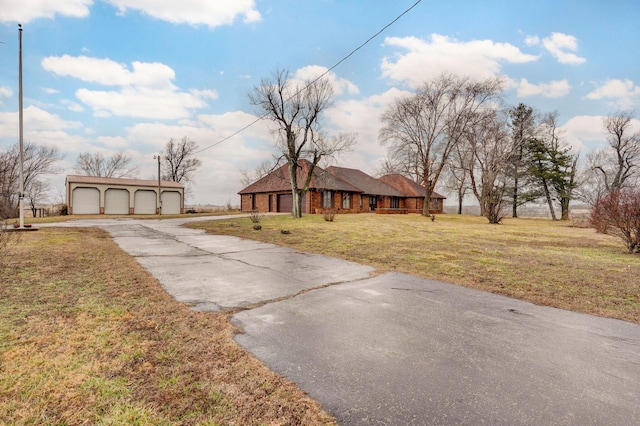 single story home featuring a garage and a front yard