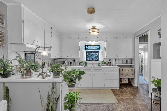 kitchen featuring sink and white cabinets