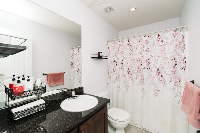 bathroom featuring toilet and vanity