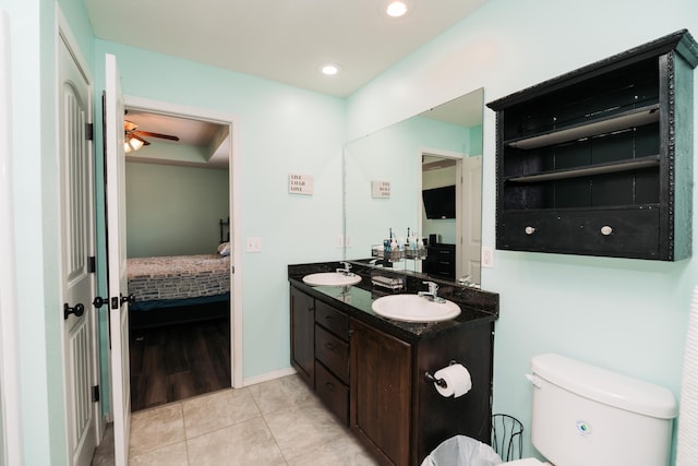 bathroom with toilet, vanity, tile patterned flooring, and ceiling fan