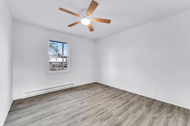 unfurnished room featuring a baseboard radiator, hardwood / wood-style flooring, and ceiling fan