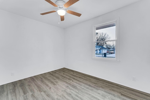 spare room featuring hardwood / wood-style floors and ceiling fan